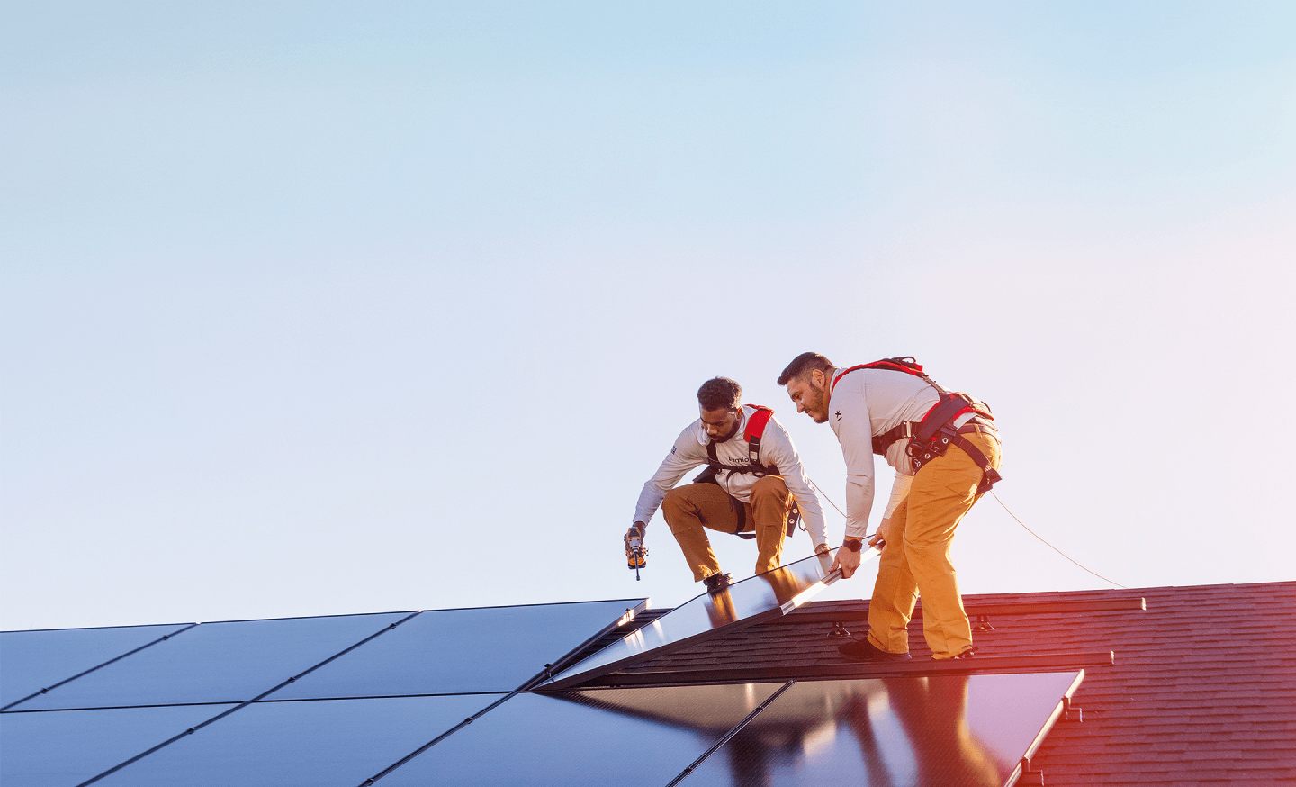 Lumio installers placing solar panel on a roof.