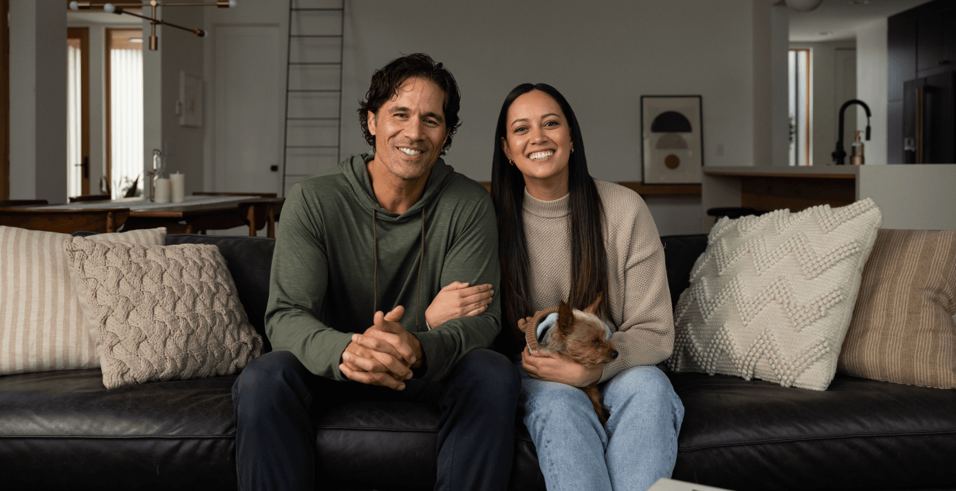 Couple and dog sitting on couch